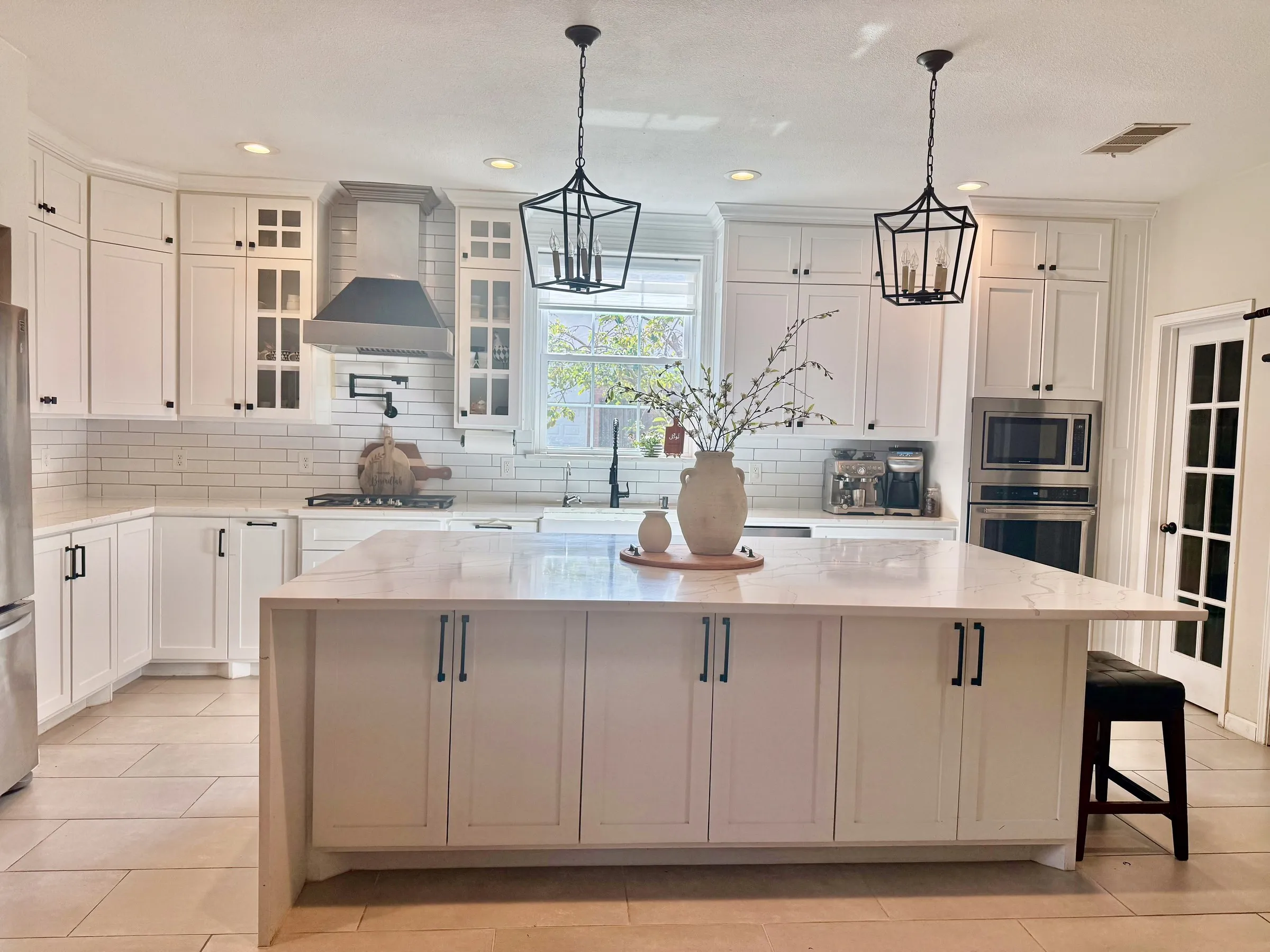Custom white shaker kitchen with marble island, pendant lighting, and subway tile backsplash built by IonBuilds in Plano, TX