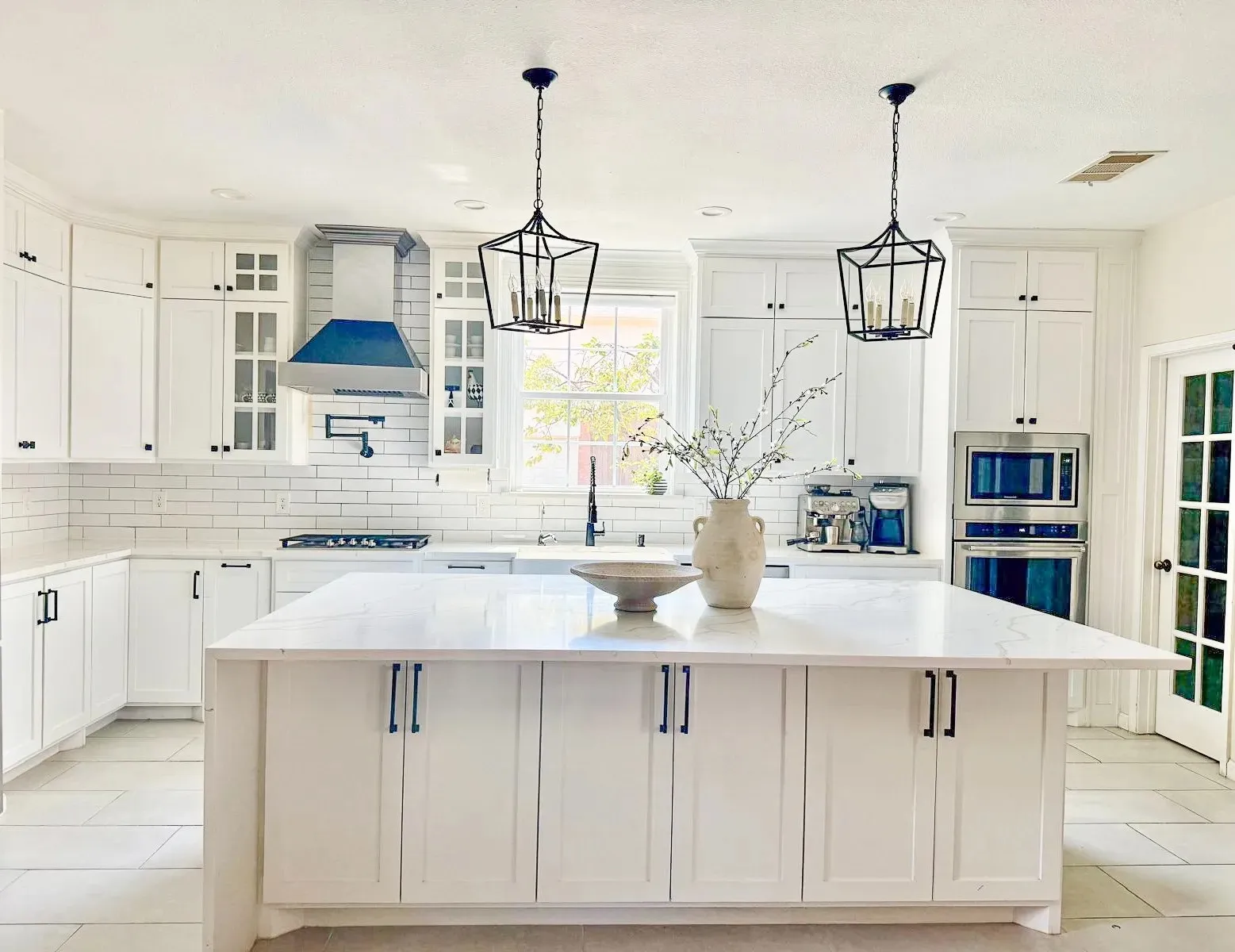 Custom white shaker kitchen with marble island, pendant lighting, and subway tile backsplash built by IonBuilds in Murphy, TX