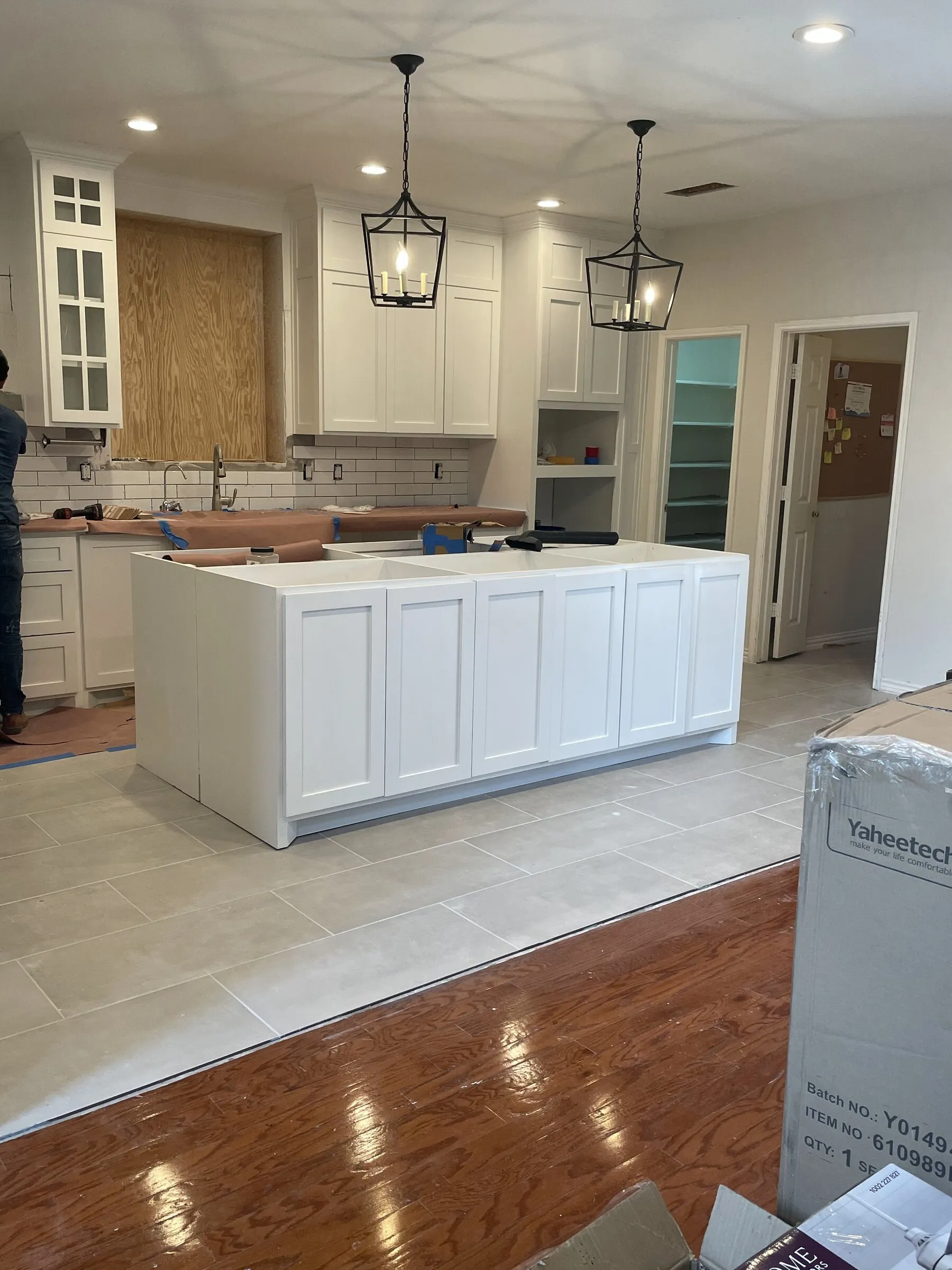 Finished white shaker kitchen with island and pendant lighting, built by IonBuilds in Plano, TX