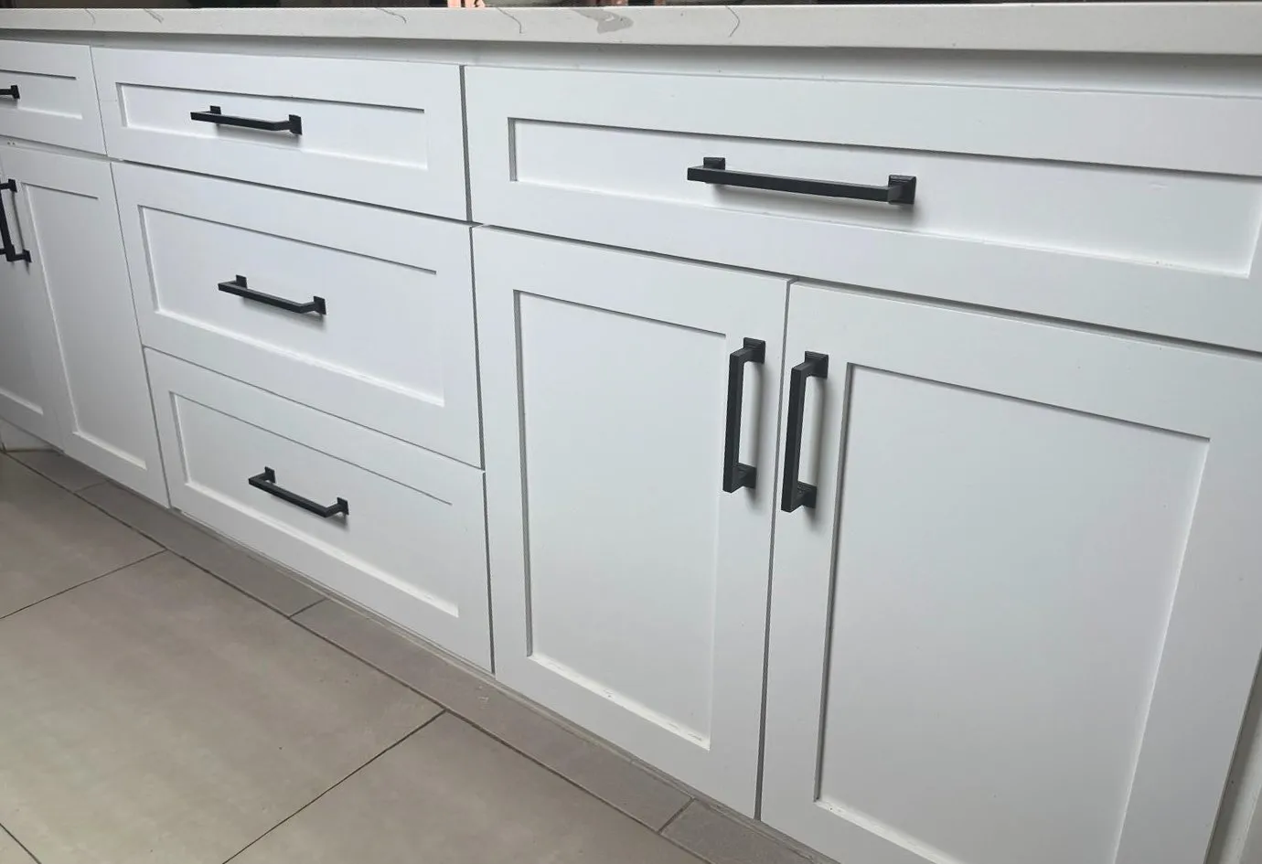 Custom kitchen range wall with white shaker cabinets by IonBuilds