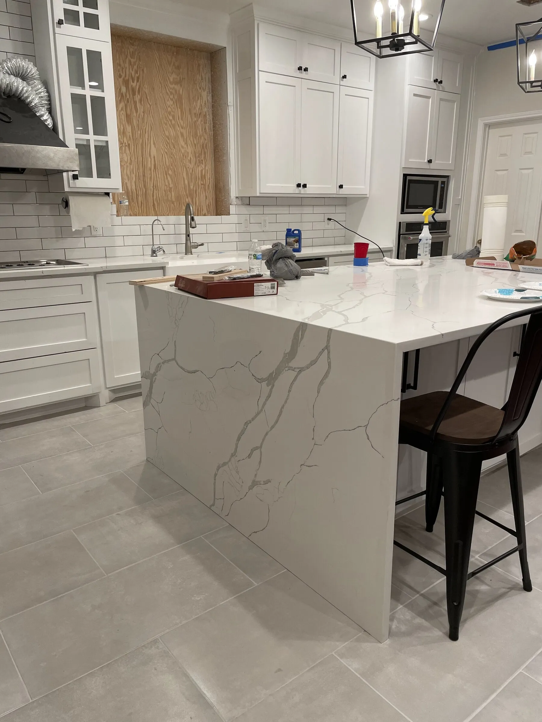 Kitchen island with waterfall-edge quartz countertop by IonBuilds