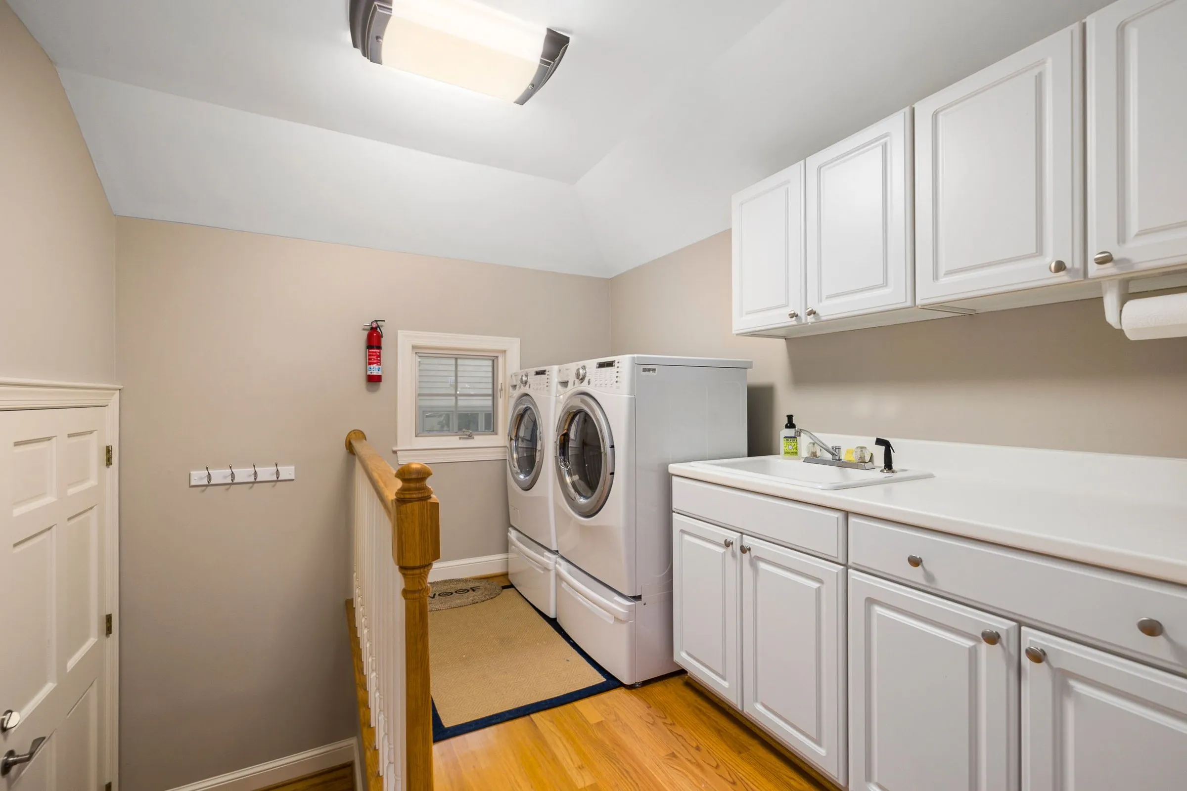 Custom laundry room cabinets with folding station by IonBuilds Plano TX