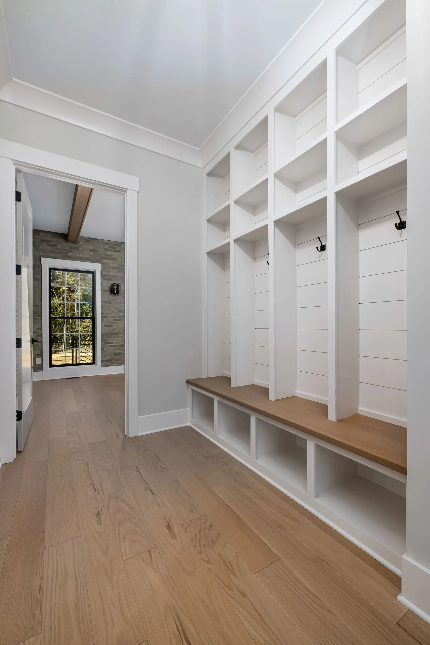 Custom mudroom locker system with bench and coat hooks by IonBuilds Plano TX