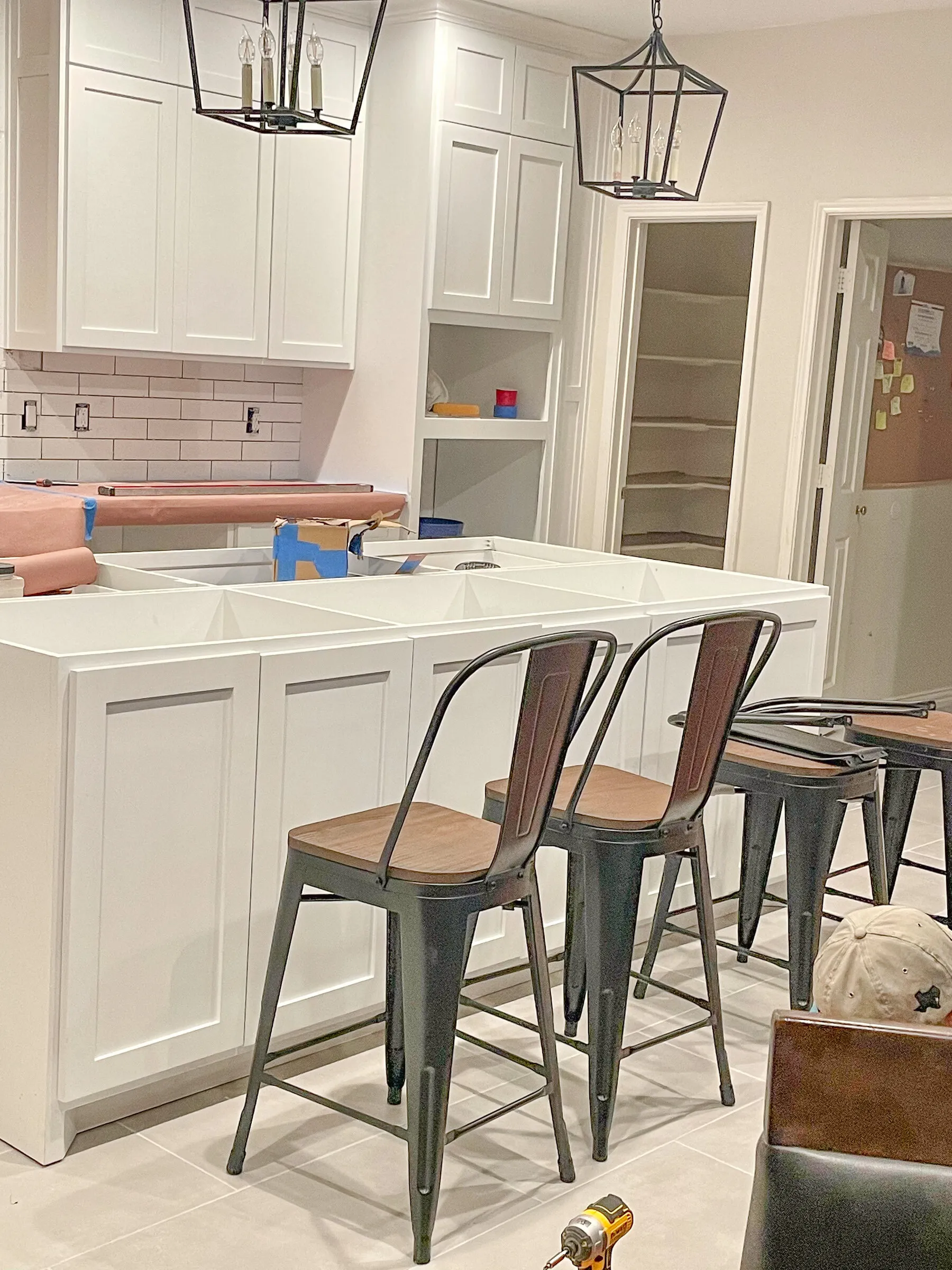 White kitchen with waterfall island and bar stools by IonBuilds