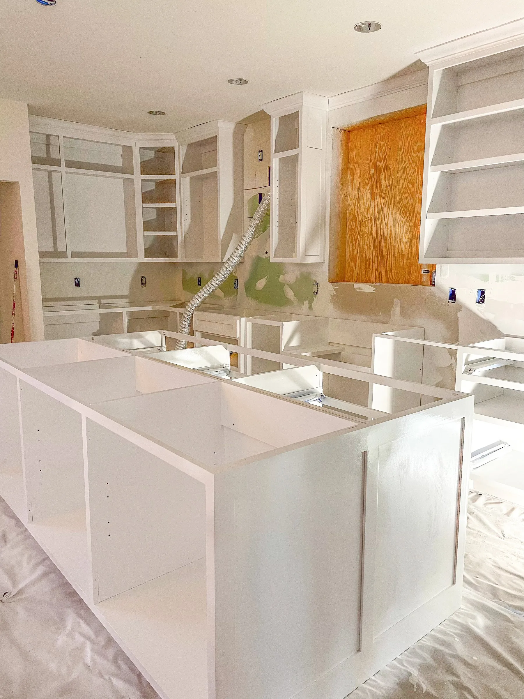 Floor-to-ceiling white pantry and oven cabinet wall by IonBuilds